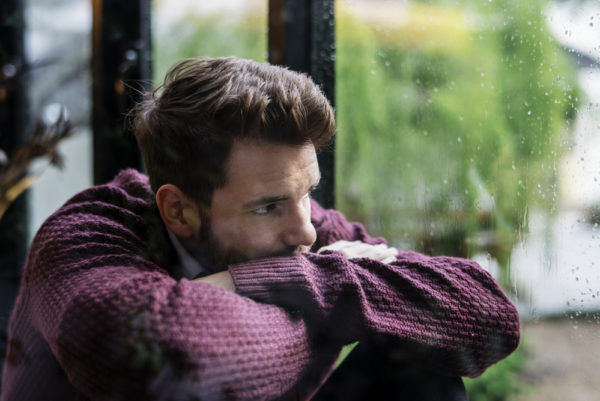 Man Staring Out Window - Deposit Photos